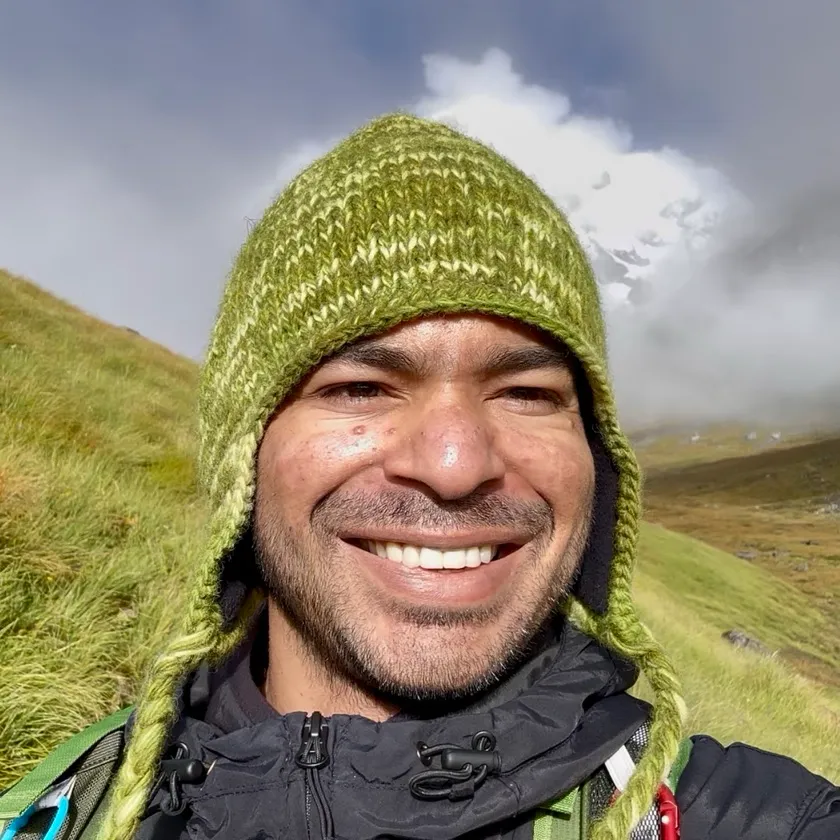 Saroj, founder of Plant Based Concept, smiling on a mountain trail